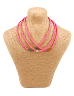 Load image into Gallery viewer, Pink African vinyl choker with orange enamel/diamond center beads
