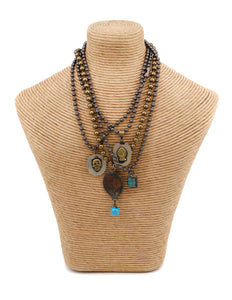 Brass ball chain necklace with a religious medallion and turquoise