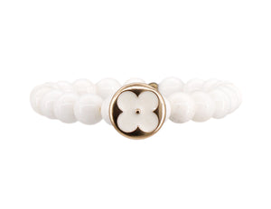 Conch bead bracelet with a gold and white designer flower button