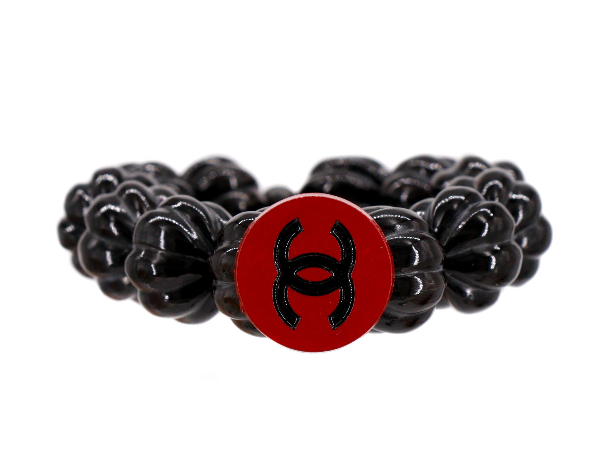 Carved black bracelet with repurposed red button